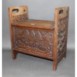 An Art & Crafts carved oak box stool, height 56cm and width 51cm.