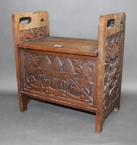 An Art & Crafts carved oak box stool, height 56cm and width 51cm.