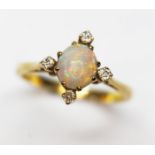 An opal and diamond ring, unmarked band, probably 18ct, gross wt. 3.2g, size M.