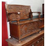 A 20th century carved oak monk's bench, length 118cm.