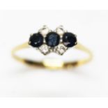 A hallmarked 18ct gold sapphire and diamond cluster ring, gross wt. 2.3g, size M.