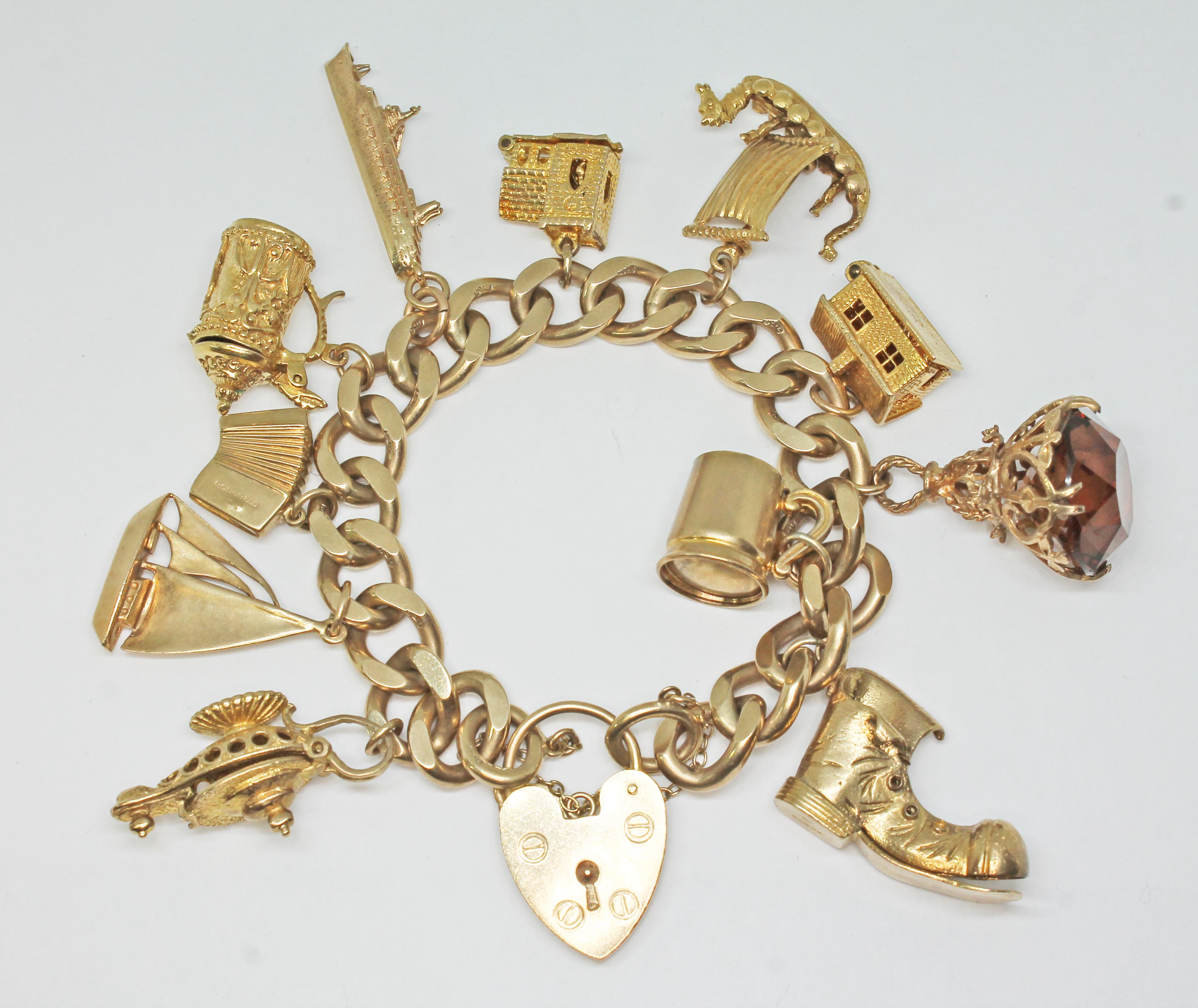 A 9ct gold charm bracelet, 10 hallmarked 9ct gold charms and hallmarked 9ct gold padlock clasp,