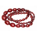 A marbled cherry bakelite graduated bead necklace, the beads ranging in length from approx. 10m to