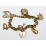 A hallmarked 9ct gold charm bracelet, gross wt. 34.4g.