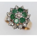 A hallmarked 9ct gold emerald and diamond cluster ring, the cluster measuring approx. 15.5mm in