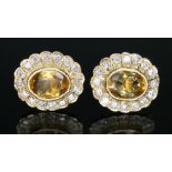 A pair of diamond and citrine cluster earrings, each oval cluster measuring approx. 12.70mm x 11.