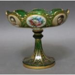 A Bohemian green glass tazza, with painted portrait and floral panels within gilt decoration, height