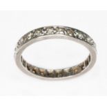 A diamond full eternity band, white metal unmarked, gross wt. 1.9g, size M. Condition - one stone