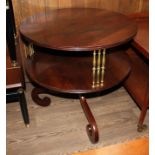 A Regency rosewood dumb waiter, two tier supported by brass columns, scroll legs, diameter 71cm &