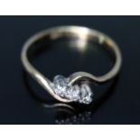 A three stone diamond ring, marked '18ct', gross wt. 1.8g, size N.
