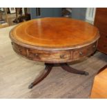 A Regency mahogany drum table, revolving tooled leather top, four drawers, three dummy drawers and