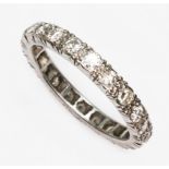 A diamond eternity band, 22 round cut diamonds weighing approx. 0.66ct in total, white metal,