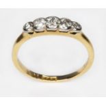 A five stone diamond ring, the bezel set stones weighing approx. 0.04, 0.06, 0.10, 0.05 & 0.03