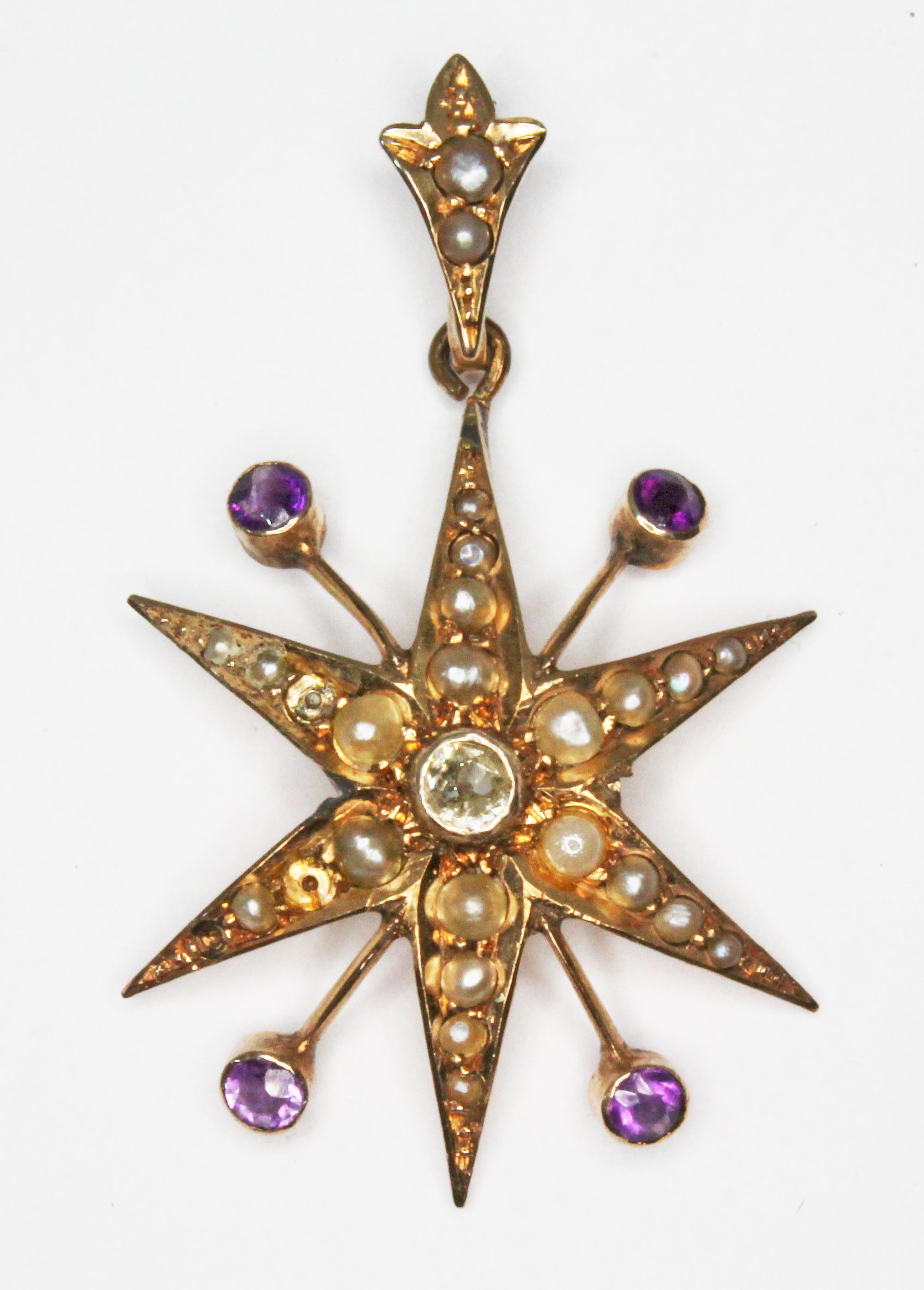 A Victorian diamond, amethyst and seed pearl pendant, the central old cut bezel set diamond weighing