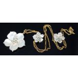A mother of pearl and topaz cluster pendant modelled as a flower with matching earrings, 9ct gold