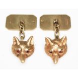 A pair of novelty cufflinks formed as fox heads and set with red gem stone eyes, maker's mark 'O.C',