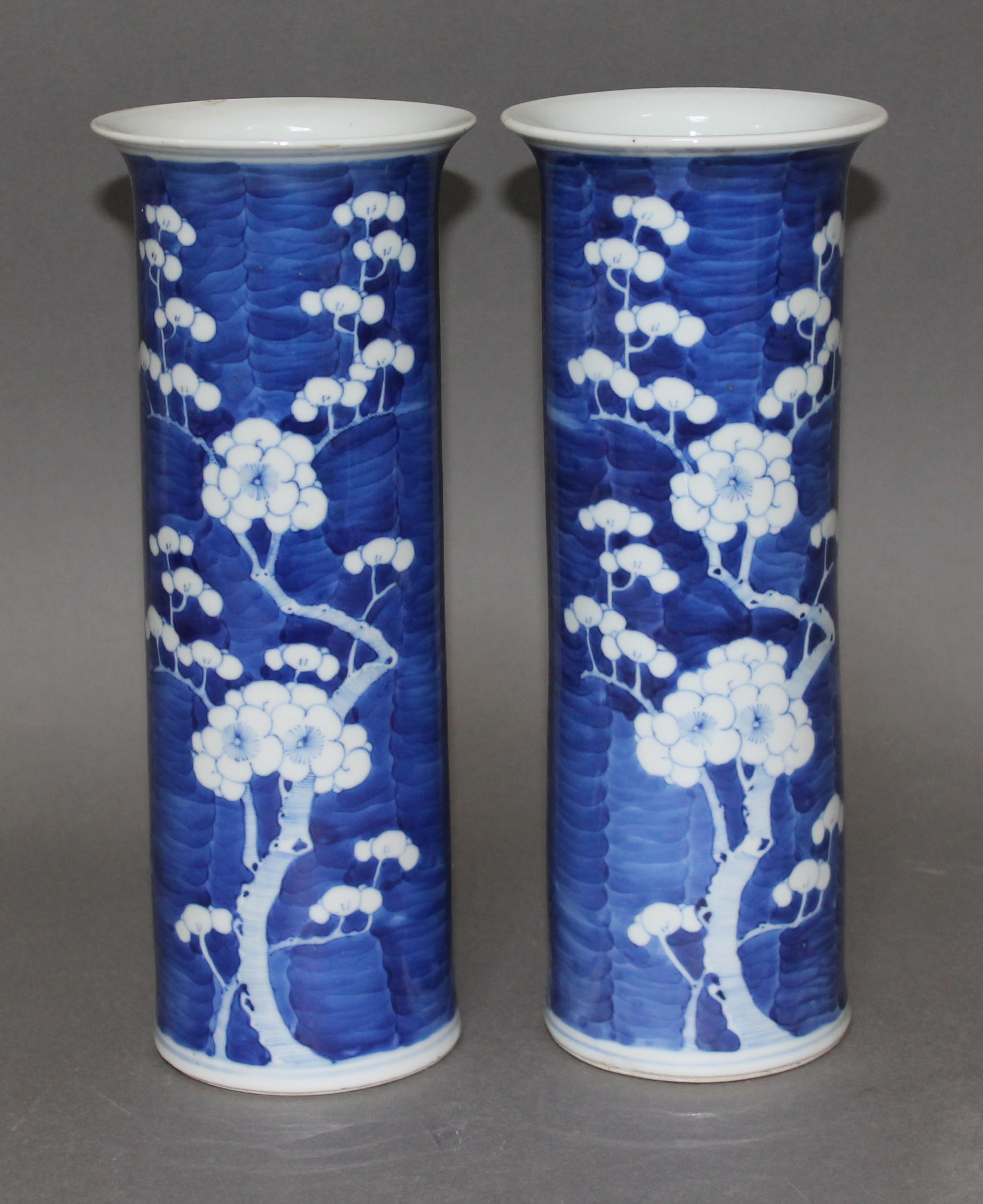 A pair of Chinese porcelain blue and white sleeve vases, each bearing four character Kangxi mark,