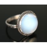 An antique moonstone cabochon ring, the bezel set flat bottom and round cut cabochon weighing