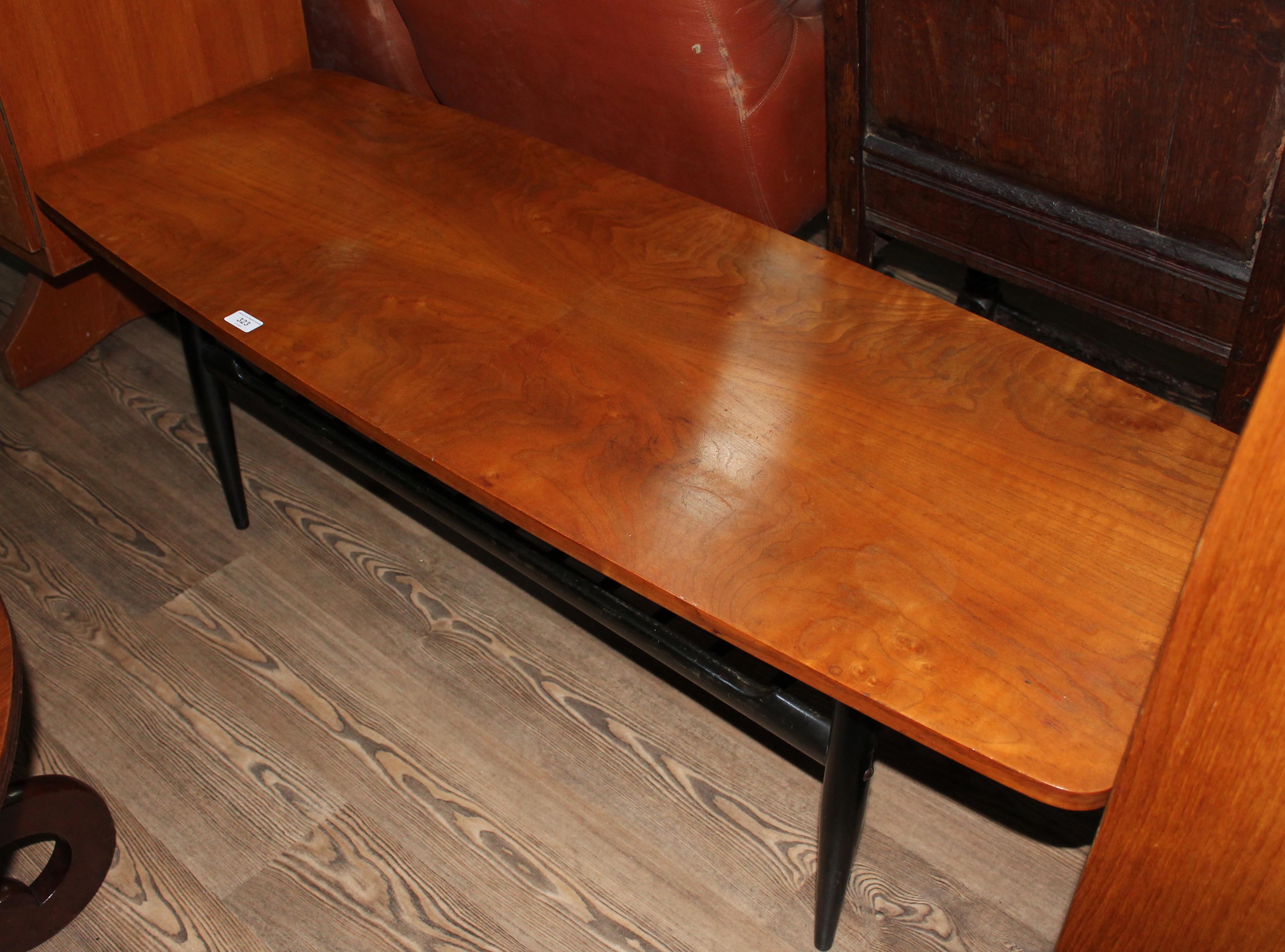 A retro quarter veneered walnut surfboard coffee table, length 137cm.