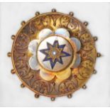 A Victorian gilt metal target brooch, set with a central pearl within blue enamel star, diameter