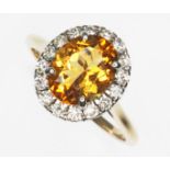 A diamond and citrine cluster ring, the oval cluster measuring approx. 13.60mm x 12.10mm, hallmarked