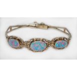 An opal doublet bracelet, each flat opal doublet surround by a wreath, marked '10K', gross wt. 9.7g,