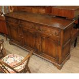 A reproduction aged oak sideboard, length 169cm, depth 46cm & height 89cm.