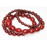 A single strand of graduated marbled cherry bakelite beads, ranging in length from approx. 8mm to