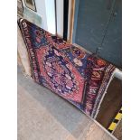 A vintage Eastern wall carpet; blue ground, approx 187 by 97 cm.