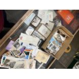 A box of vintage photographs and postcards
