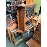 An oak and leaded glass wall cabinet, a cane and glass top table and four mirrors.