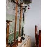 Two gilt metal floor standing lamps together with a metal and glass floor standing lamp.