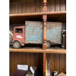 A tin plate toy truck with opening rear doors