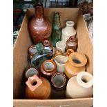 A box of stoneware and glass bottles.