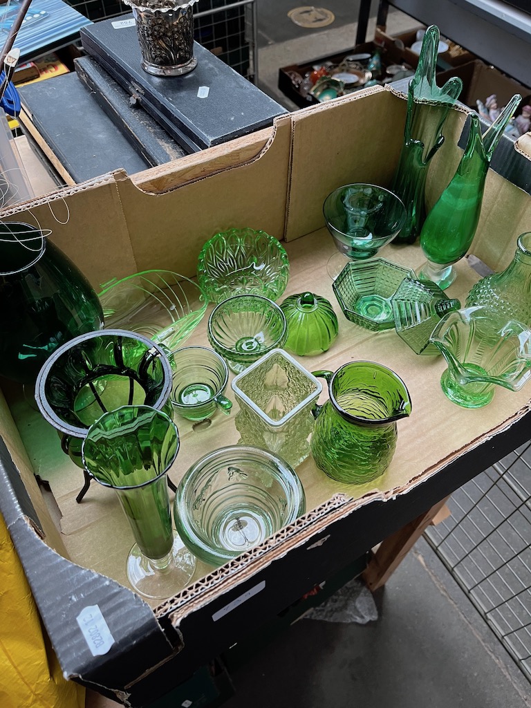 A box of green glass items.