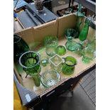 A box of green glass items.