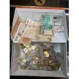 A box of mixed coins and notes.