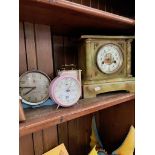 Four clocks comprising two alarm clocks, a carriage clock and a mantel clock.