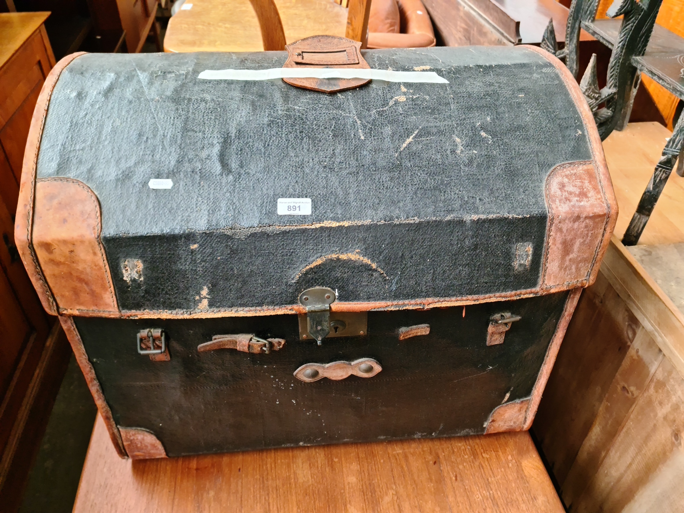 A vintage dome top and leather bound travel trunk.