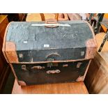 A vintage dome top and leather bound travel trunk.