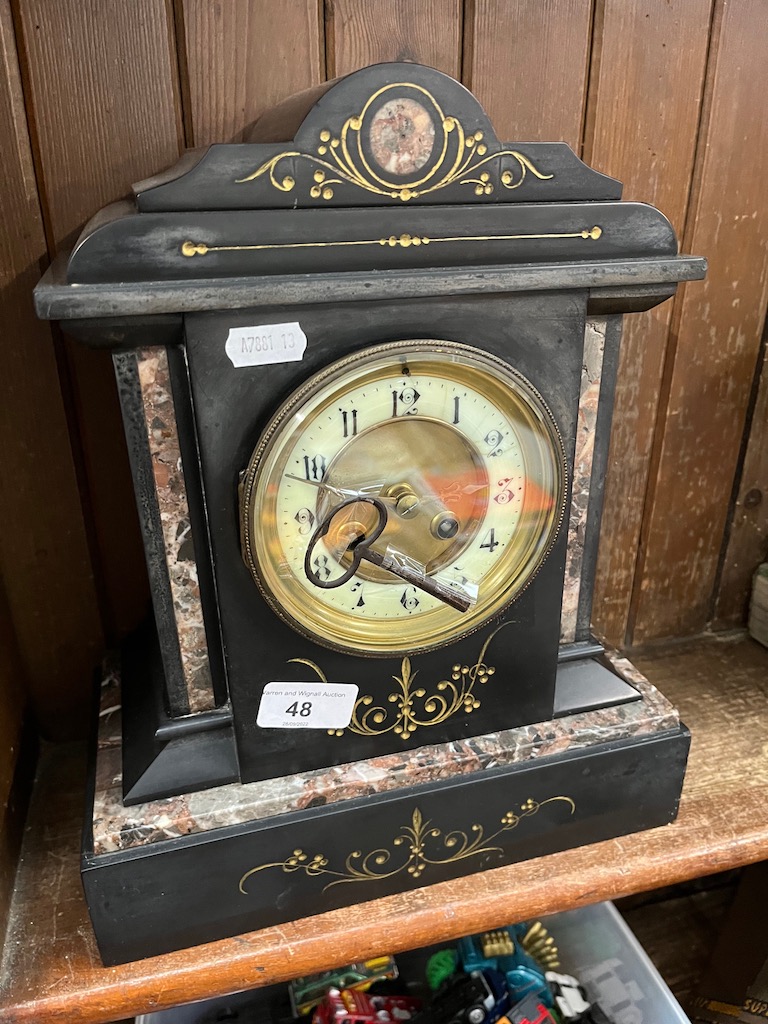 A black slate and marble mantel clock.