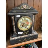 A black slate and marble mantel clock.