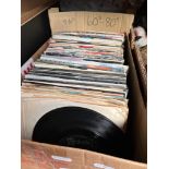 A collection of vintage 45s from 1950s to 1980s, and two boxes of DVDs including comedies from 1980s