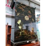 A Chinese black lacquer side cabinet decorated with flowers.