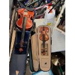 2 violins with bows in cases.