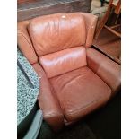 A tan leather recliner armchair.