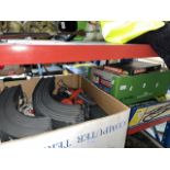 A box of Scalextric track, a multi level raceway system, and a box of games