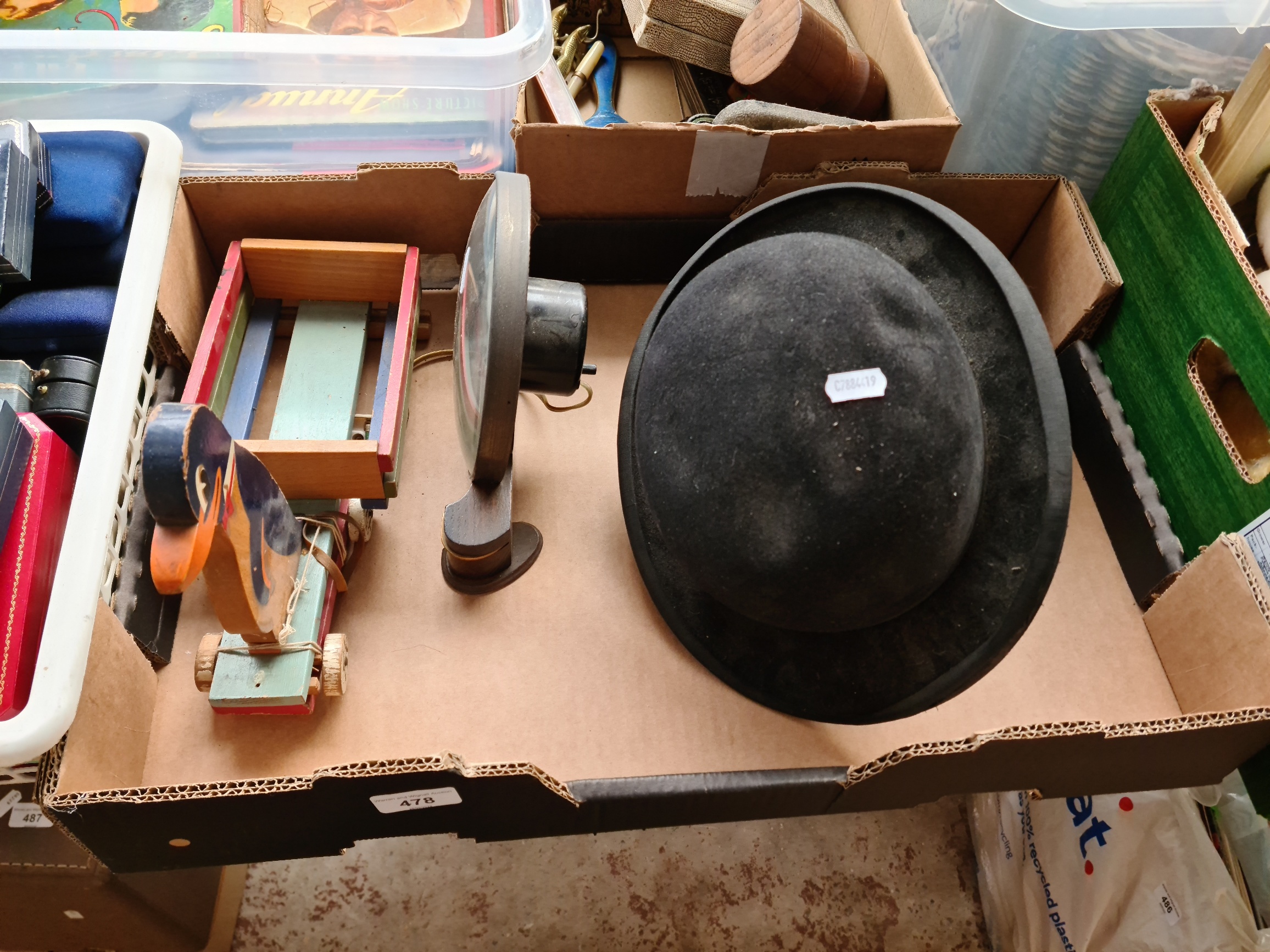 Two bowler hats, a vintage Smiths electric clock, and a vintage pull along toy