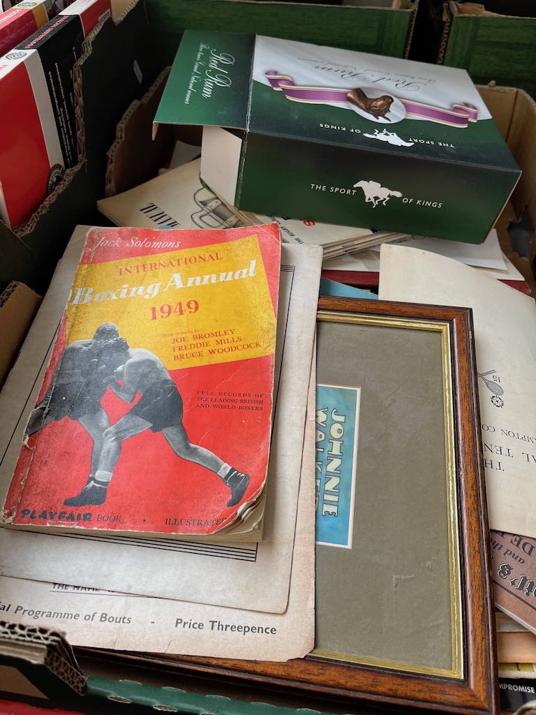 A box of sporting memorabilia, circa 1950s to 1980s, including programmes, signatures, athletics,