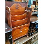 A mahogany magazine rack.